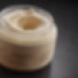 A close-up view of a luxurious cellulite cream jar with a delicate texture