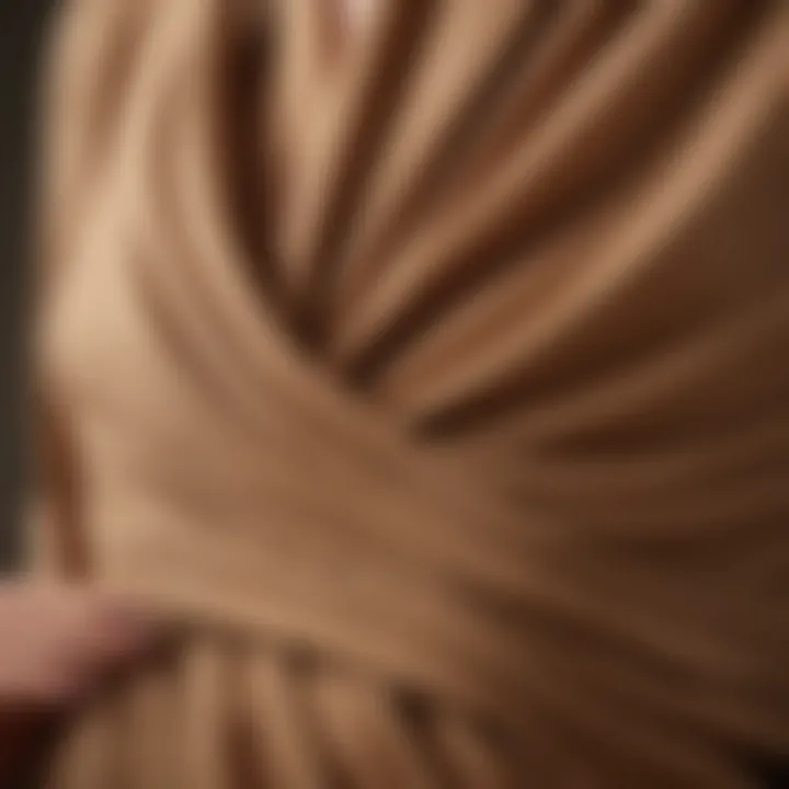 A close-up of the fabric texture of a camel maternity dress emphasizing comfort.