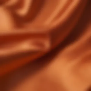 Intricate Silk Fabric Detail Close-up of intricate silk fabric texture in vibrant orange hue