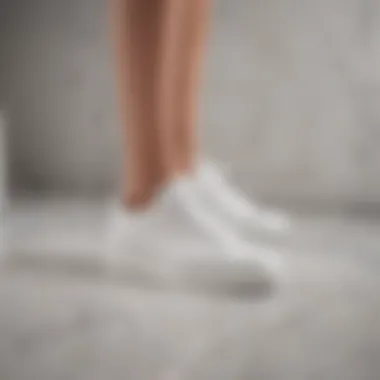 Elegant white sneakers on marble floor