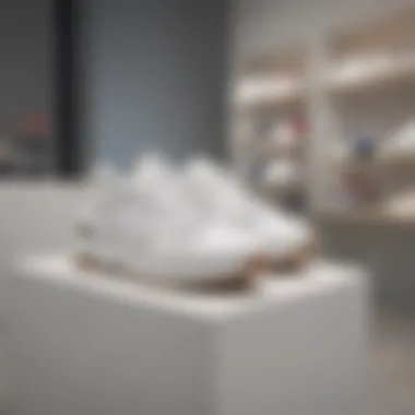 Trendy Retail Display of Athletic Shoes Stylish white leather athletic shoes on display in a trendy retail environment