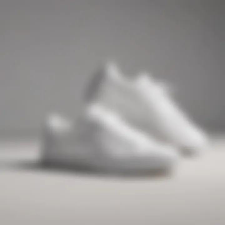 Clean all-white tennis shoes on a minimalistic background